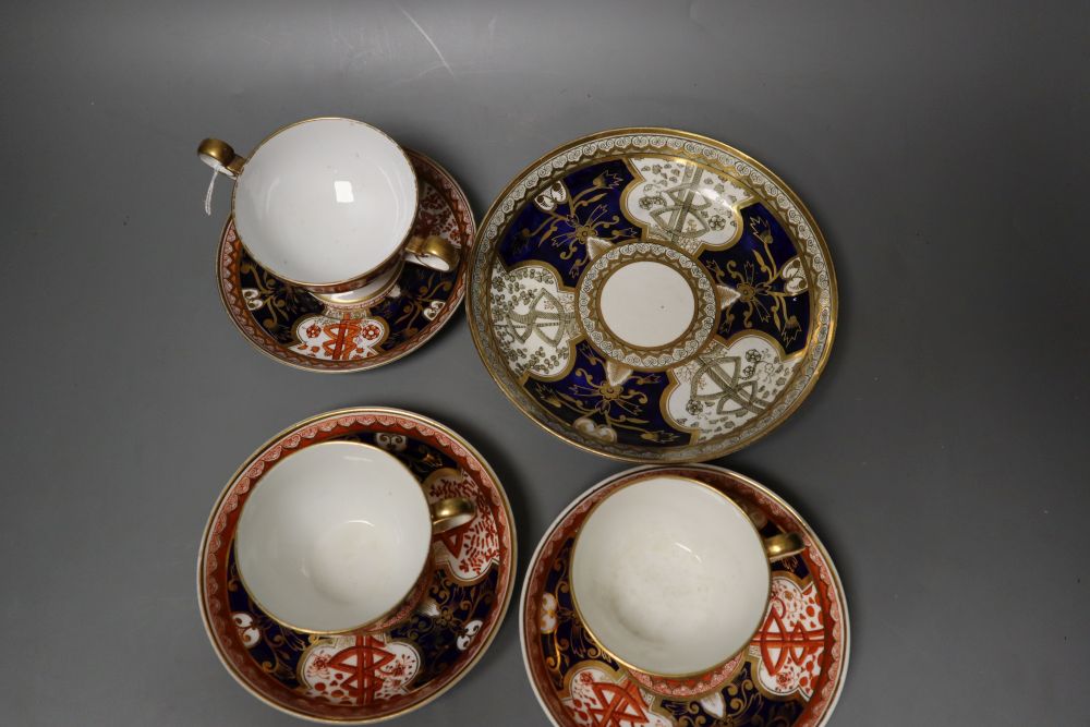 A Spode Dollar pattern two handled cup and saucer, two teacups and saucer and a saucer dish in a different version of the Dollar patter